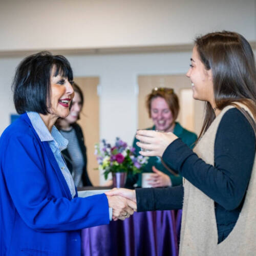Student shaking the President of GVSU's hand.